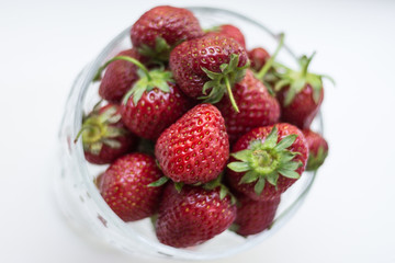 sweet fragrant strawberries in a glass vase isolated on white background