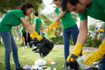Environmental activists wrapped up in work: they divided into pairs and collecting garbage in city...