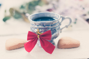 cup of coffee and biscuit on a white wooden boards