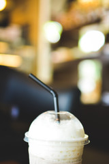 Ice coffee on a wooden table in coffee shop background hipster tone soft and selective focus 