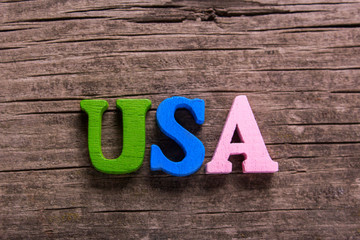 Fototapeta premium usa word made from colored wooden letters on an old table. Concept