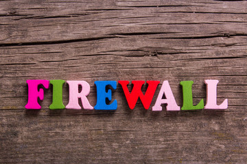 Fototapeta premium firewall word made from colored wooden letters on an old table. Concept