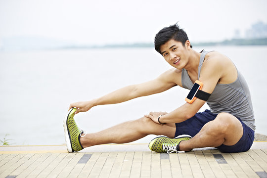 young asian man exercising outdoors