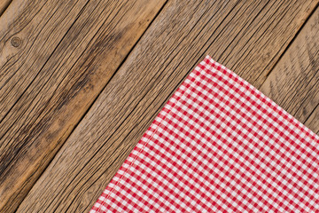 The checkered tablecloth on wooden table.