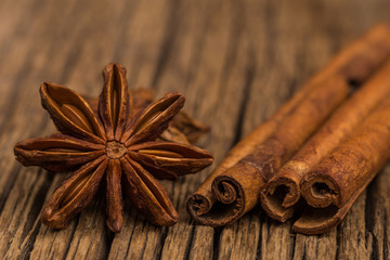 Star anise and cinnamon on old wooden table.