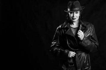 Elegant fashionable woman wearing black coat and hat