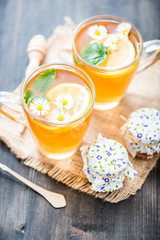 chamomile tea in a glass cup on wooden background