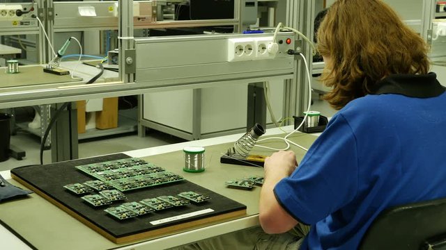Engineer repair printed circuit board with soldering iron