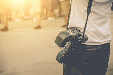photographer holding camera, close-up.Vintage tone.