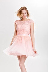 Fototapeta premium beautiful sensual and sexy blond woman in pink cocktail dress po