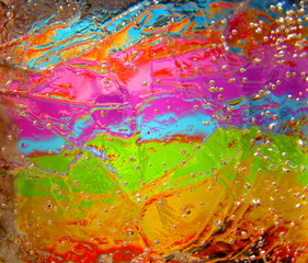 Colorful ice background. Natural abstract ice pattern texture with bubbles illuminated spectral...