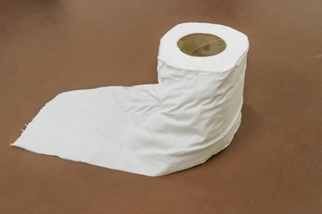 Toilet paper on brown background - tissue paper roll