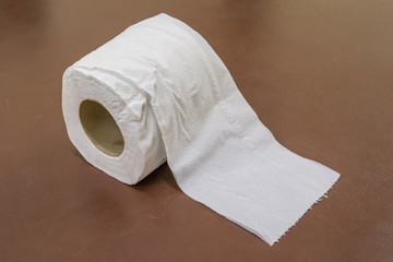 Toilet paper on brown background - tissue paper roll
