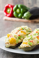 Stuffed eggplant with quinoa and vegetables on wooden background
