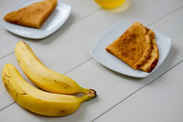 Pancakes with bananas and chocolate served on a plate