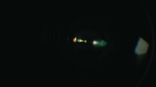 Camera lens reflection macro with color lens flare. LED lamp