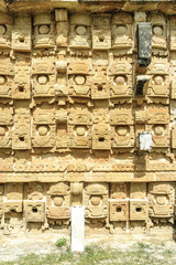 large masks of the Mayan god Chaac in the front of the palace of the masks or Codz Poop in the archaeological Kabah enclosure in Yucatan, Mexico.