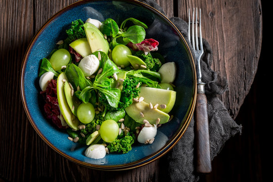 Fresh Kale Salad With Mix Of Vegetables And Avocado