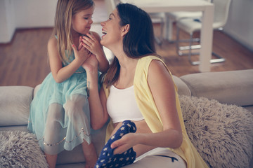 Pregnant woman with her daughter.