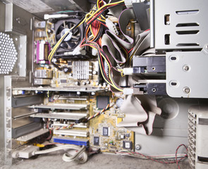 Inside of the old, disassembled, covered with dust computer. Small depth of sharpness..