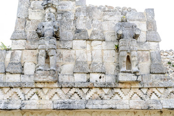Mayan sculptures in the palace of the masks or Codz Poop in the archaeological kabah enclosure in Yucatan, Mexico.