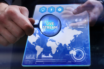 Business, Technology, Internet and network concept. Young businessman showing a word in a virtual tablet of the future: Live stream