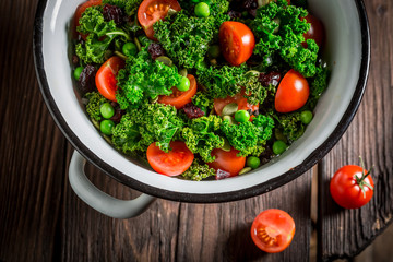 Diet kale salad with green peas and cherry tomatoes