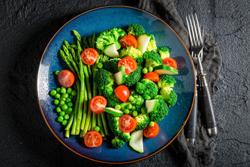 Spring salad with broccoli, asparagus and cherry tomatoes