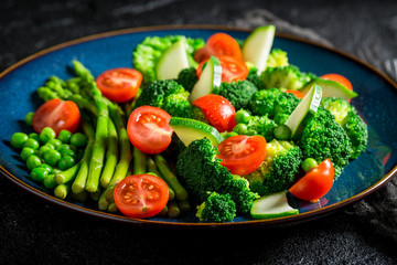 Fresh salad with cherry tomatoes, asparagus and broccoli
