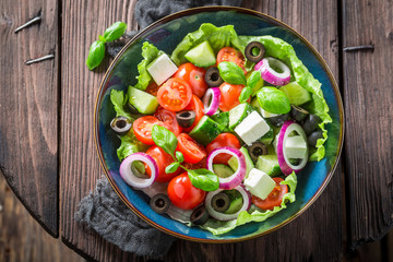Spring Greek salad with cherry tomatoes, lettuce and onion