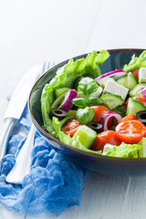 Healthy Greek salad with cherry tomatoes, lettuce and onion