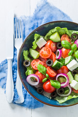 Colorful Greek salad with feta cheese, black olives and lettuce
