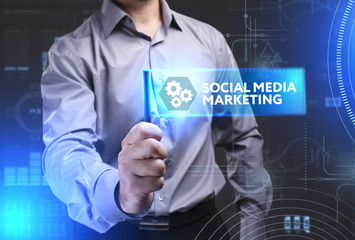 Business, Technology, Internet and network concept. Young businessman showing a word in a virtual tablet of the future: Social media marketing