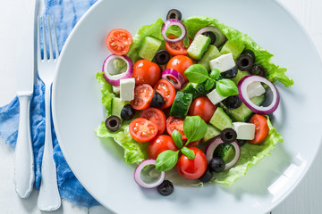 Classical Greek salad with feta cheese, black olives and lettuce