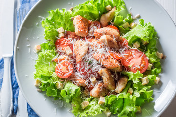 Delicious Caesar salad with chicken, cherry tomatoes and parmesan cheese