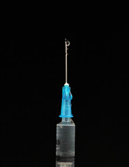 Medical injection syringes with solution on black background. Macro image.