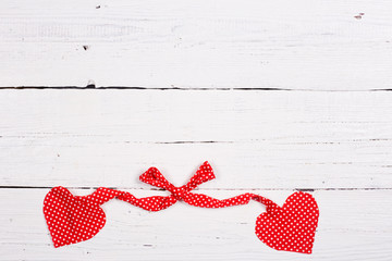 Wooden background with two red hearts