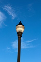 A light pole with the blue sky in the background.