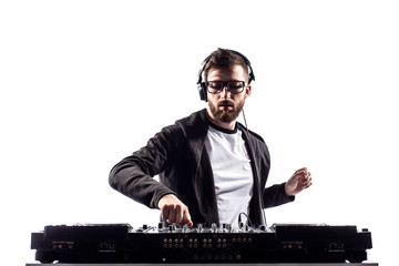 Young stylish man in glasses posing behind mixing console on white studio background.