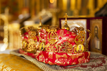 Fototapeta na wymiar orthodox crown for a wedding in the church, background golden and blur