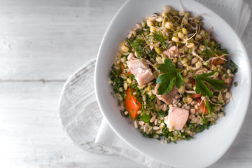 Healthy salad on the white wooden table top view