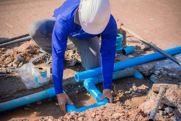 Construction worker,Repairing a broken water pipe on the concrete road.