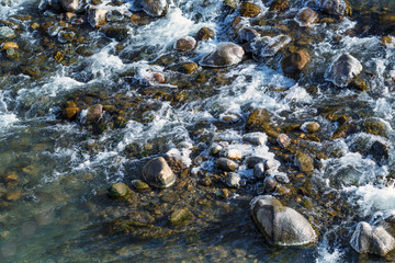 Raging water in threshold of the mountain river
