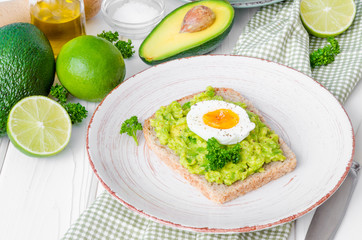 Sandwich with whole grain bread, mashed avocado and boiled eggs