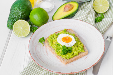 Sandwich with whole grain bread, mashed avocado and boiled eggs