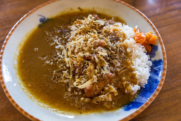 Fried baby octopus curry rice and dried fish.