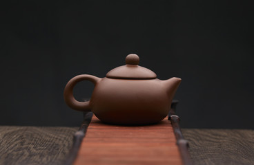 Traditional tea ceremony accessories, teapot with wooden background