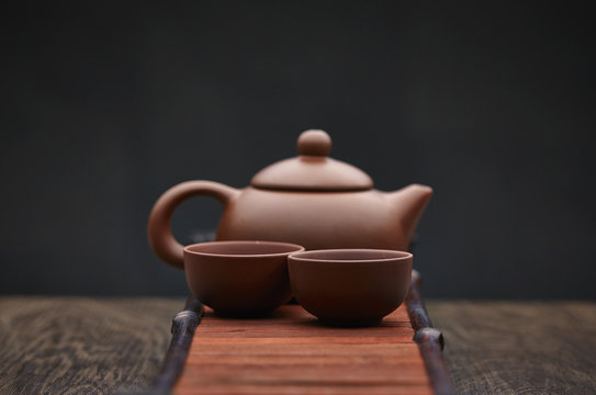 Traditional tea ceremony accessories, teapot and teacup with wooden background