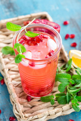 Infused pomegranate water with fresh lemon and ice, cold healthy refreshing and detox drink