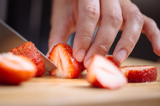 Knife cutting a strawberry